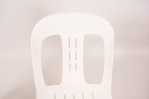 White plastic stack chair front
